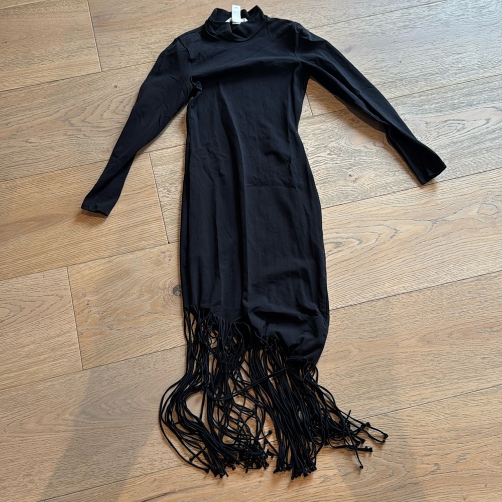 Black form fitting H&M dress that has fringe on the bottom size extra small